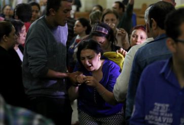 A relative of a victim reacts inside the Coptic church that was bombed on Sunday in Tanta
