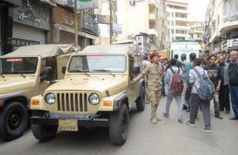 An Egyptian army member looks on at a scene after an attack by a suicide bomber in front of a church in Alexandria