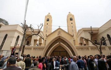 Egyptians gather in front of a Coptic church that was bombed on Sunday in Tanta