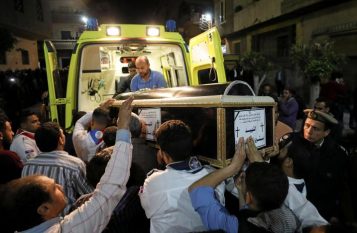 A coffin is carried out of an ambulance outside of the Coptic church that was bombed on Sunday in Tanta