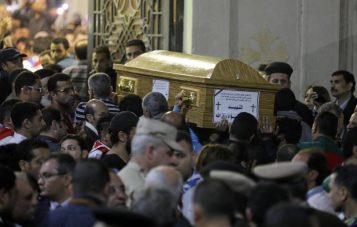 A coffin is carried inside a Coptic church that was bombed on Sunday in Tanta