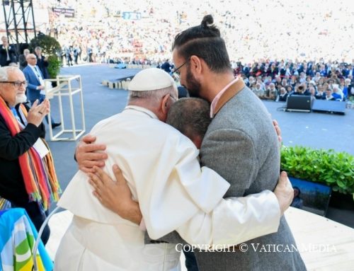 An Israeli and Palestinian, both victims of Gaza war, embrace before Pope Francis